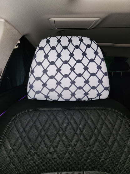 Close-up of Keffiyeh design on white headrest cover inside vehicle interior