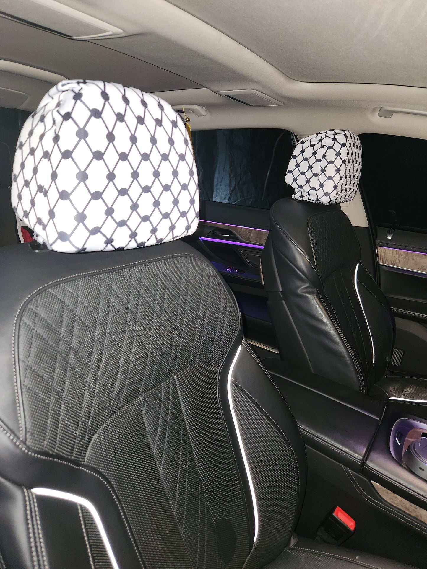 Palestinian Kufiya design car headrest covers on rear seats, white pattern over black leather