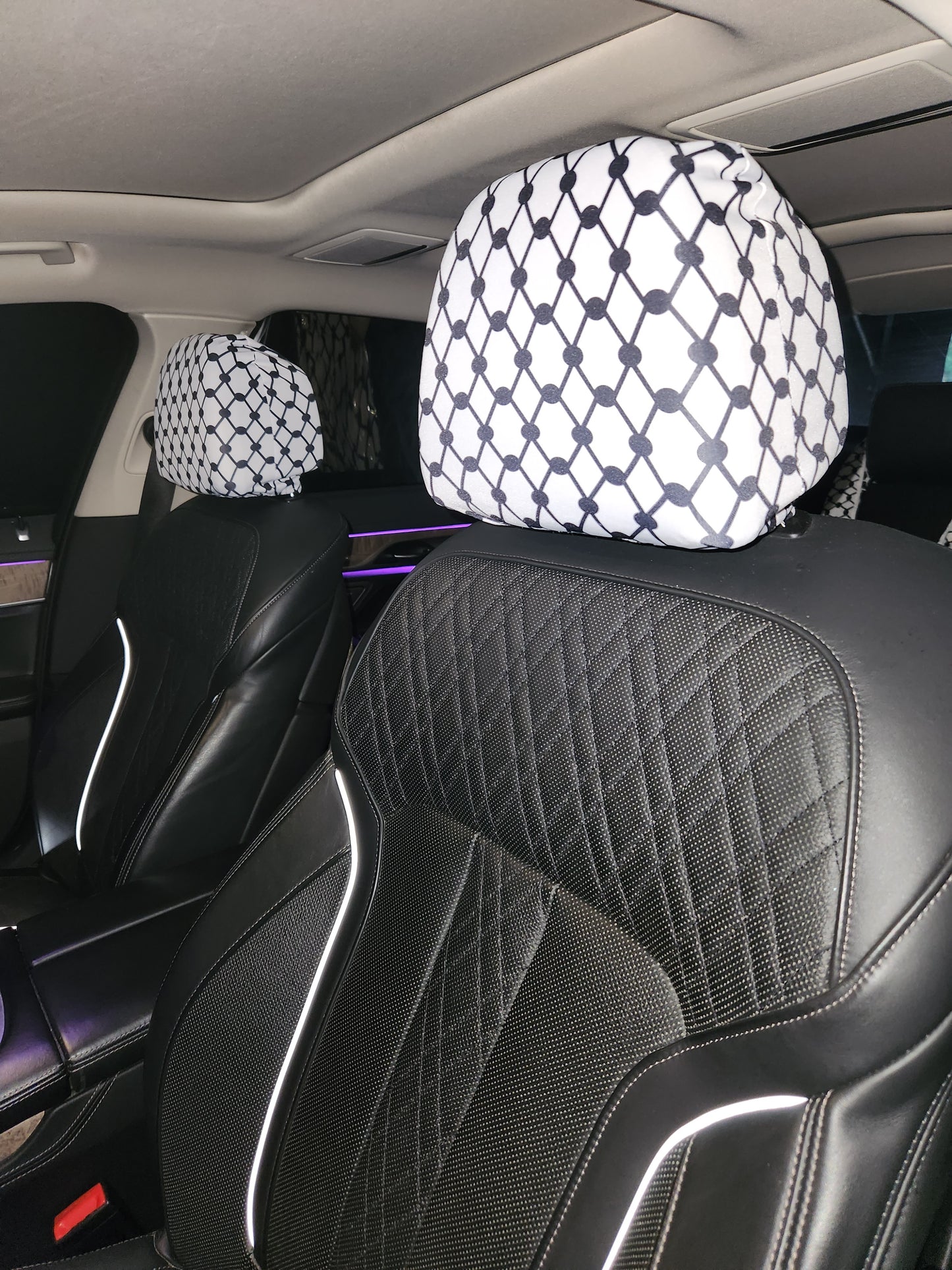 White Keffiyeh car headrest covers installed on black leather seats, Palestinian Kufiya design