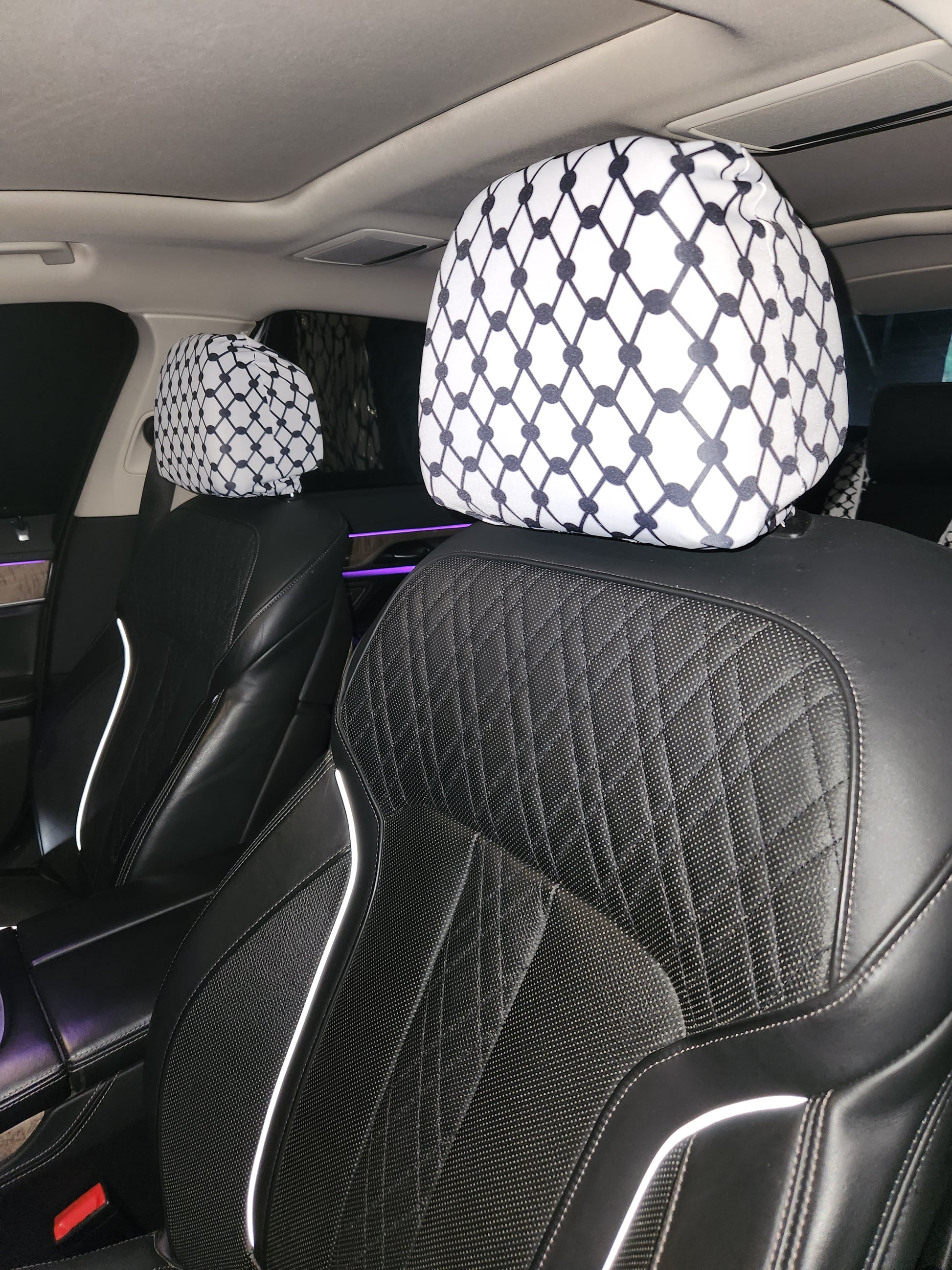 White Keffiyeh car headrest covers installed on black leather seats, Palestinian Kufiya design