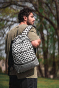 Person wearing Palestinia FC Keffiyeh Backpack with kufiya pattern symbolizing Palestinian heritage, unity, and resilience