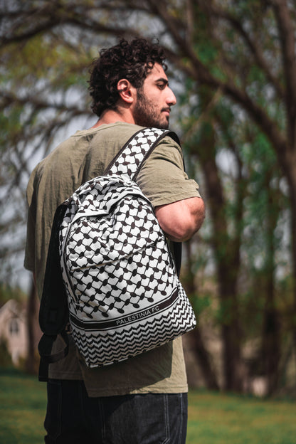 Person wearing Palestinia FC Keffiyeh Backpack with kufiya pattern symbolizing Palestinian heritage, unity, and resilience