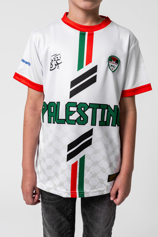 Child wearing a white sports jersey with 'Palestine' printed on it, featuring red, green, and black colors.