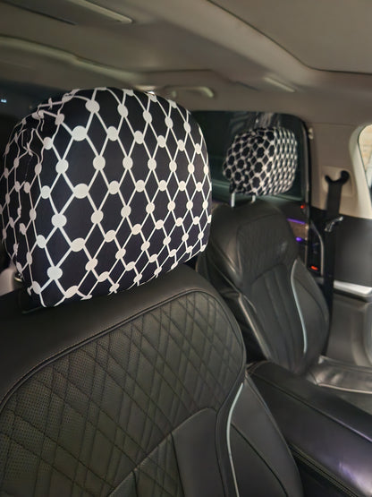 Black Kiffiyeh car headrest cover installed on leather seats, showing Palestinian Kufiya pattern