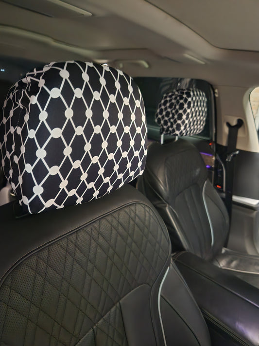 Black Kiffiyeh car headrest cover installed on leather seats, showing Palestinian Kufiya pattern