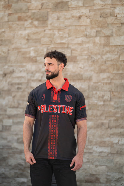Model wearing black Palestine jersey with Tatreez red embroidery pattern outdoors