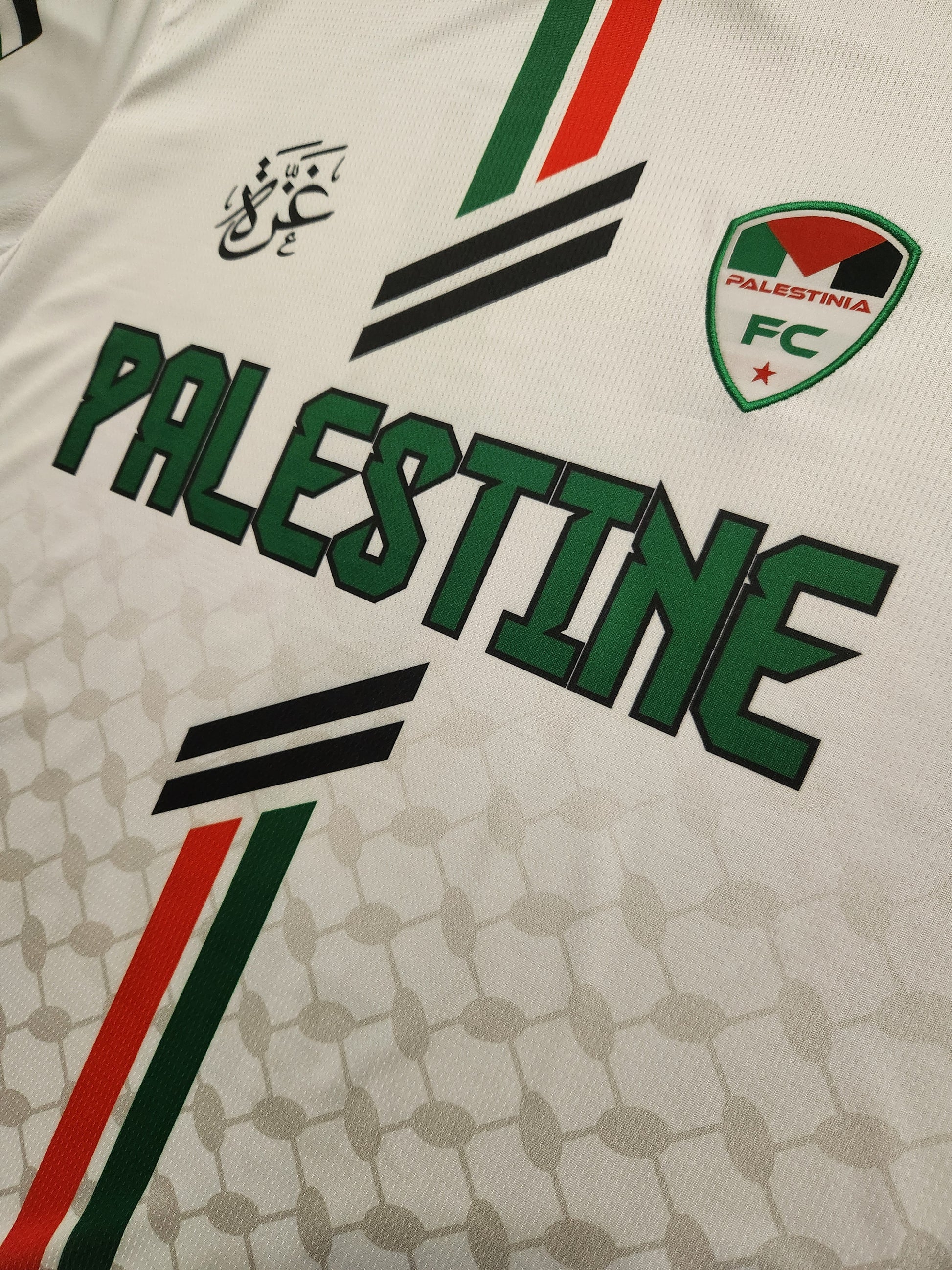Jersey with 'Palestine FC' branding and colors on a keffiyeh textured background